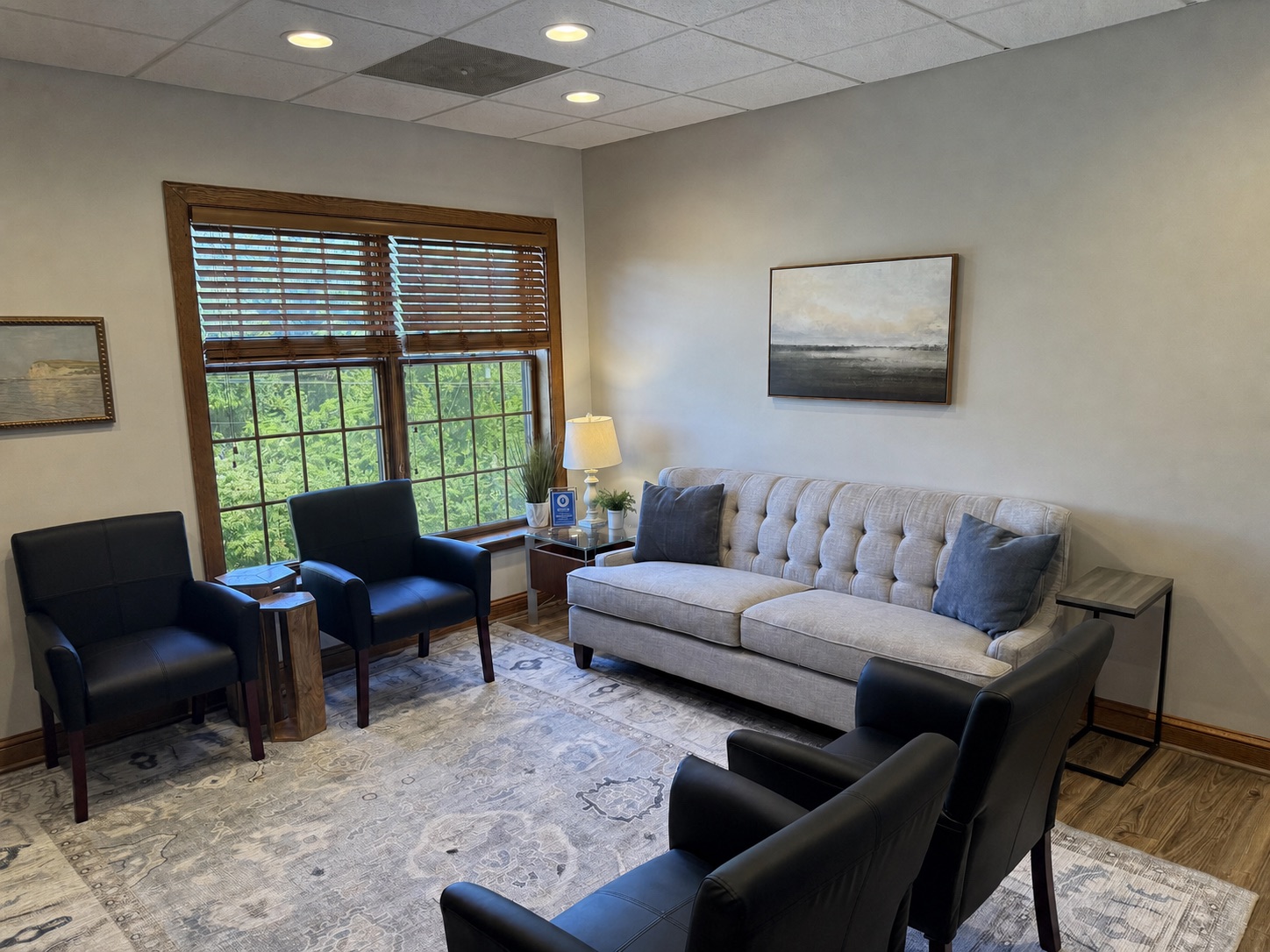 A quiet waiting area at Rooted in Care Therapy with soft seating and natural light